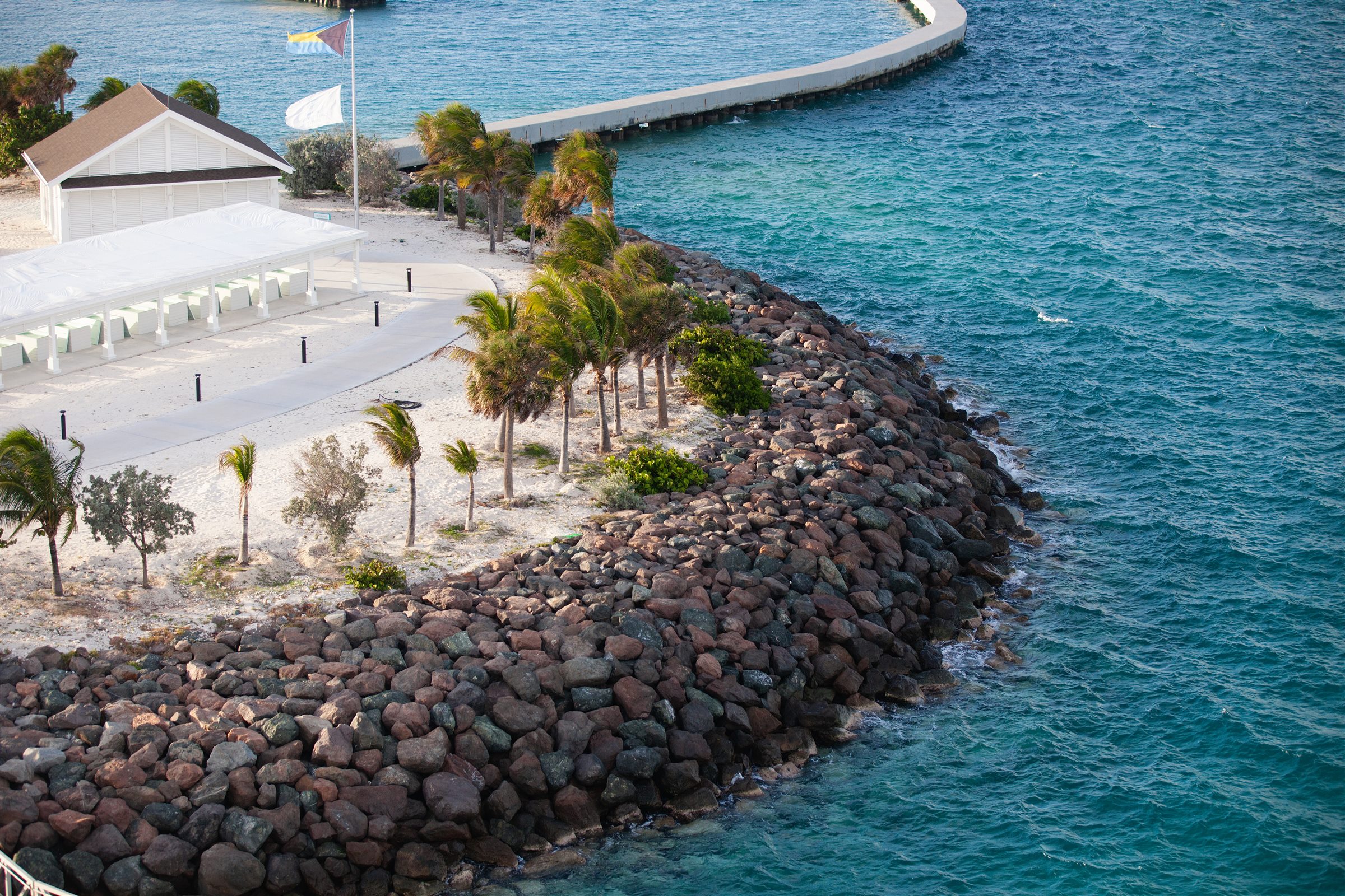 Rocky shoreline and clear blue water at Ocean Cay