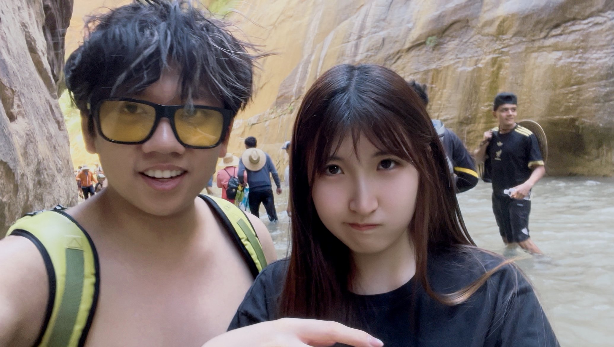 Cici and Yisen hiking through the Narrows at Zion