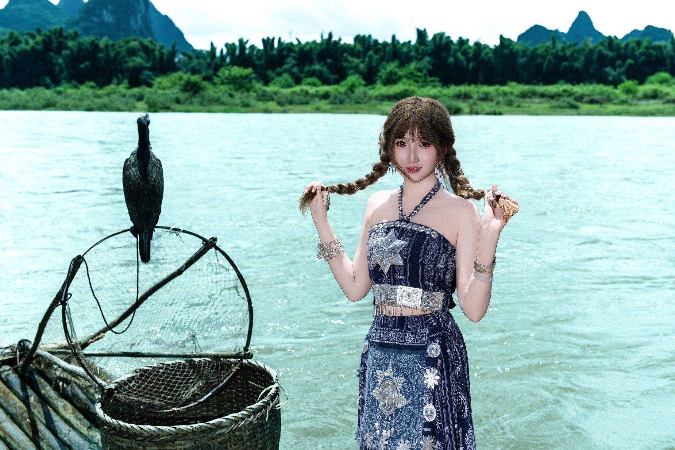 Cici portrait by the river with karst mountains in the background