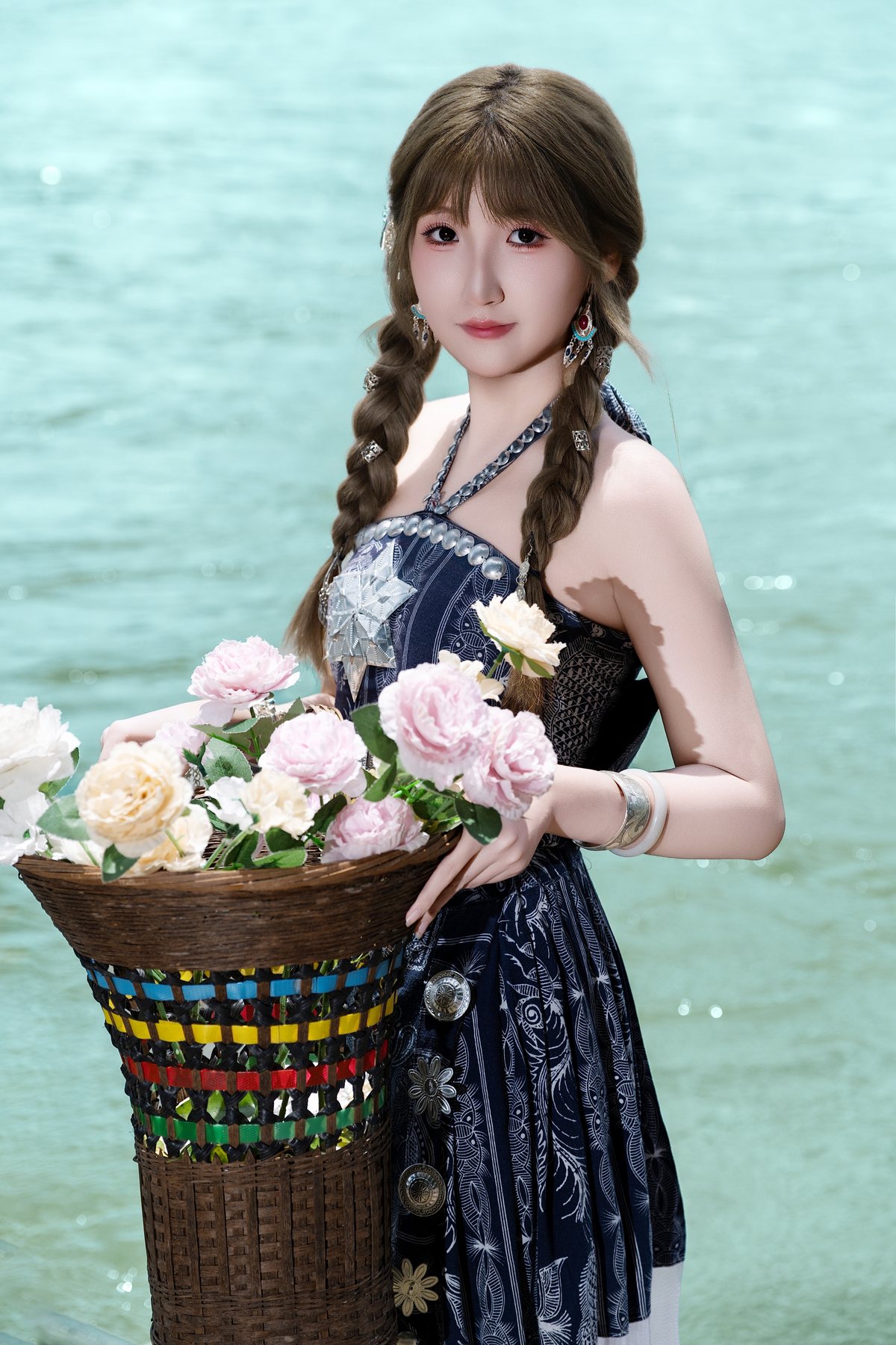 Cici holding a flower basket by the water