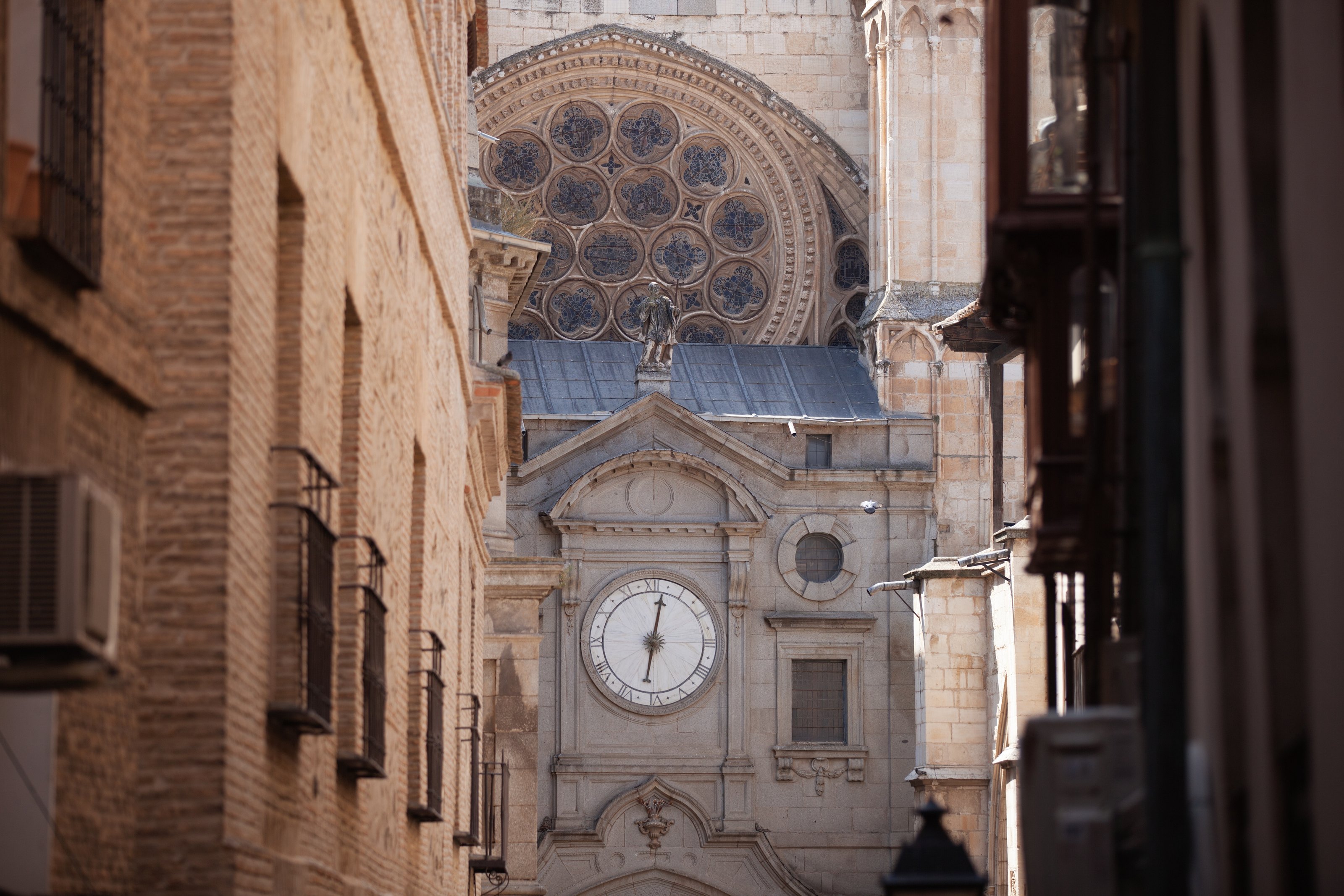 Cathedral clock seen through warm city walls
