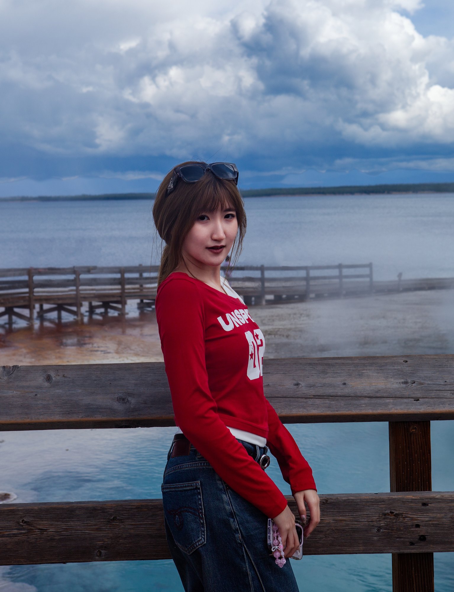 Cici at Yellowstone's lakeshore beneath storm clouds